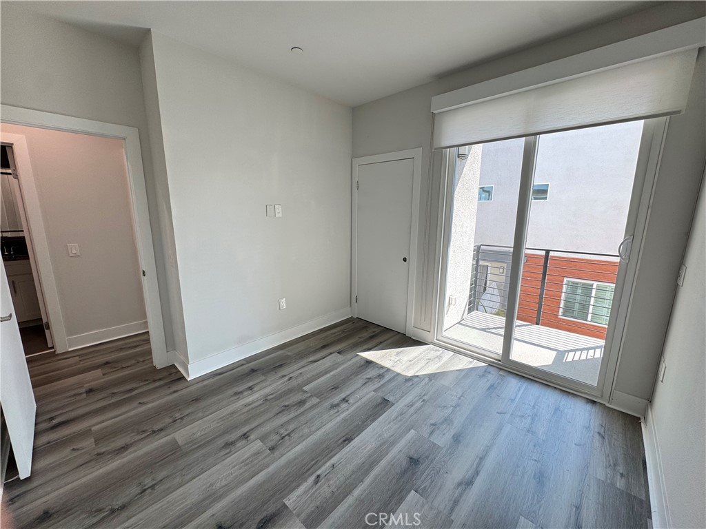 7958 Telegraph Road Downey, CA 90240 - Photo 17 of 38 an empty room with wooden floor and entrance