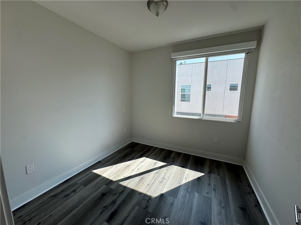 7958 Telegraph Road Downey, CA 90240 - Photo 20 of 38 an empty room with wooden floor and windows