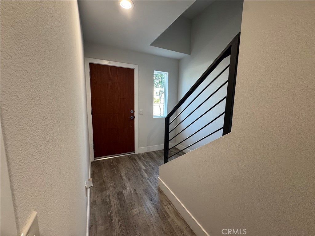 7958 Telegraph Road Downey, CA 90240 - Photo 22 of 38 a view of a hallway with wooden floor and staircase