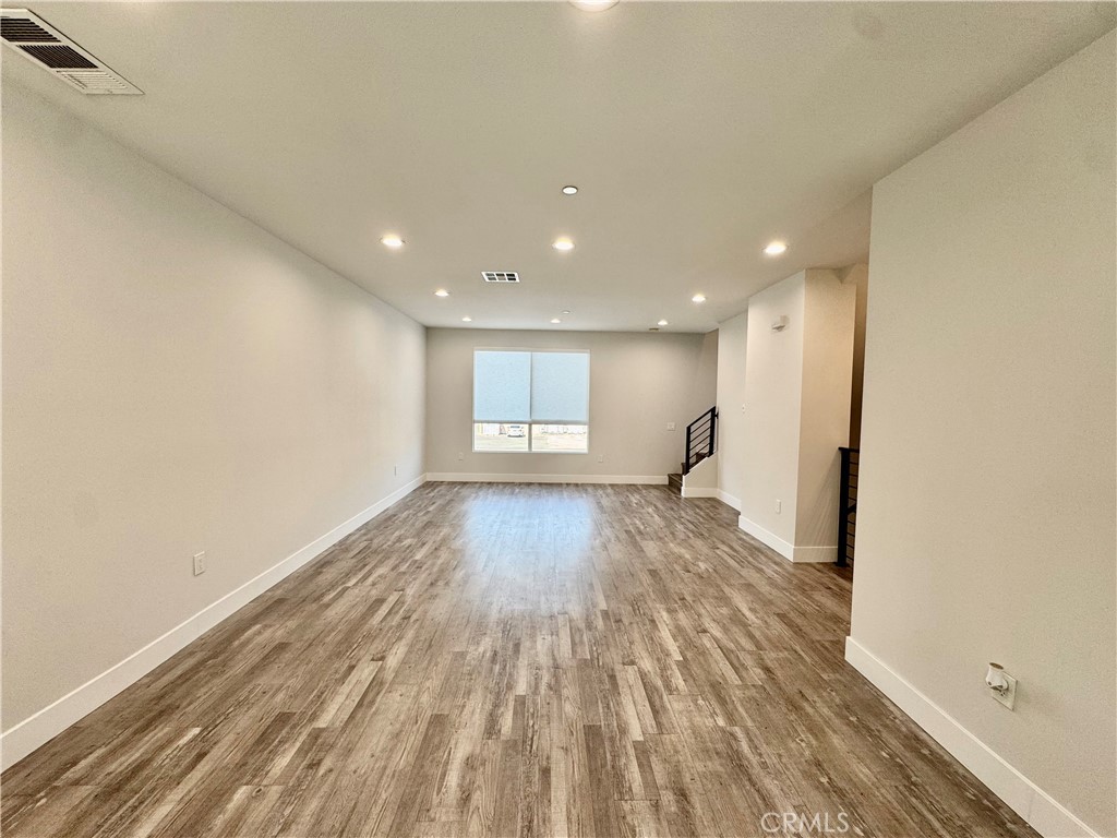 7958 Telegraph Road Downey, CA 90240 - Photo 3 of 38 a view of empty room with wooden floor and fan