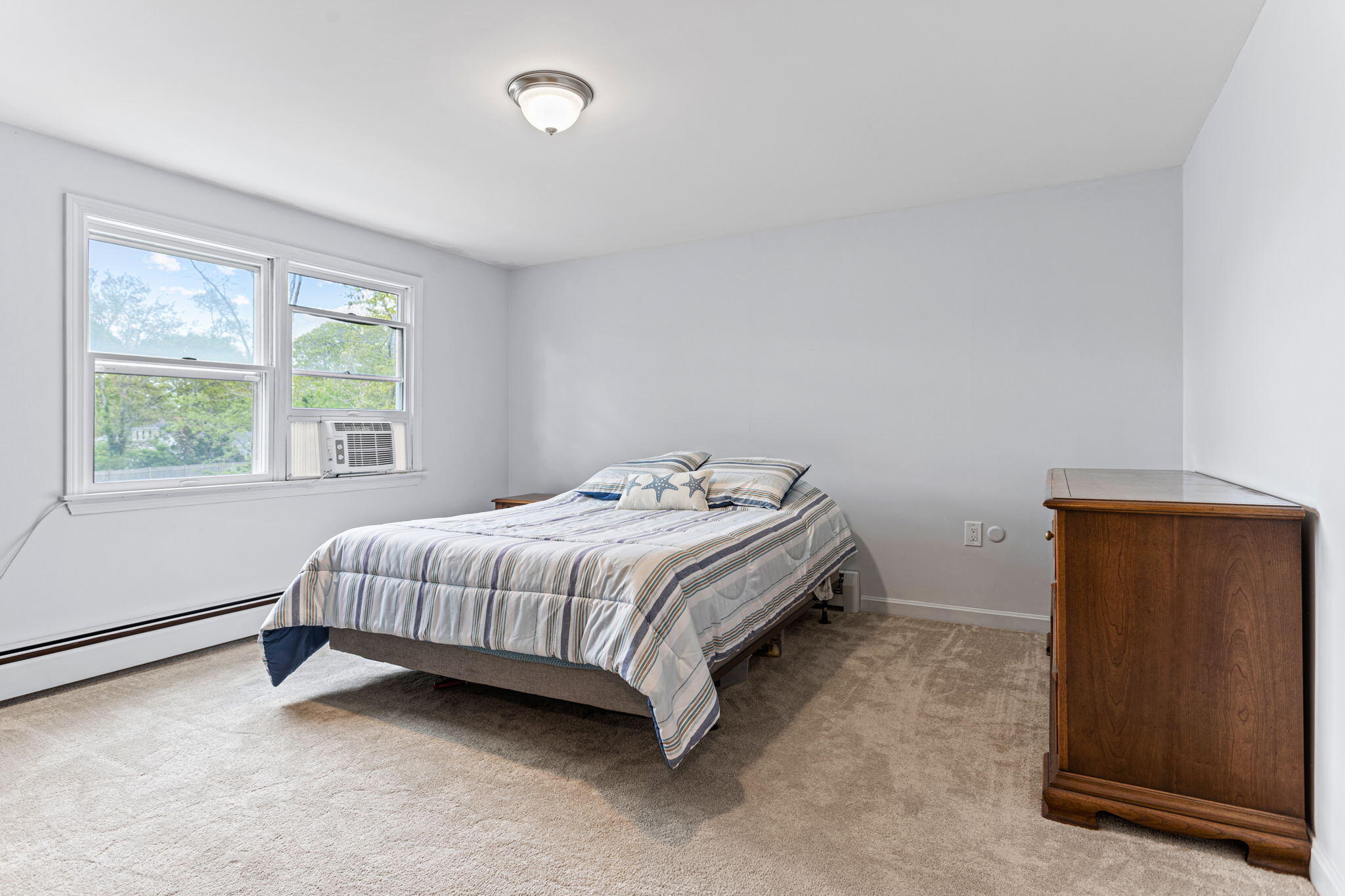 75 Lake Leaman Road Falmouth, MA 02540 - Photo 16 of 30 a bed sitting in a bedroom next to a window