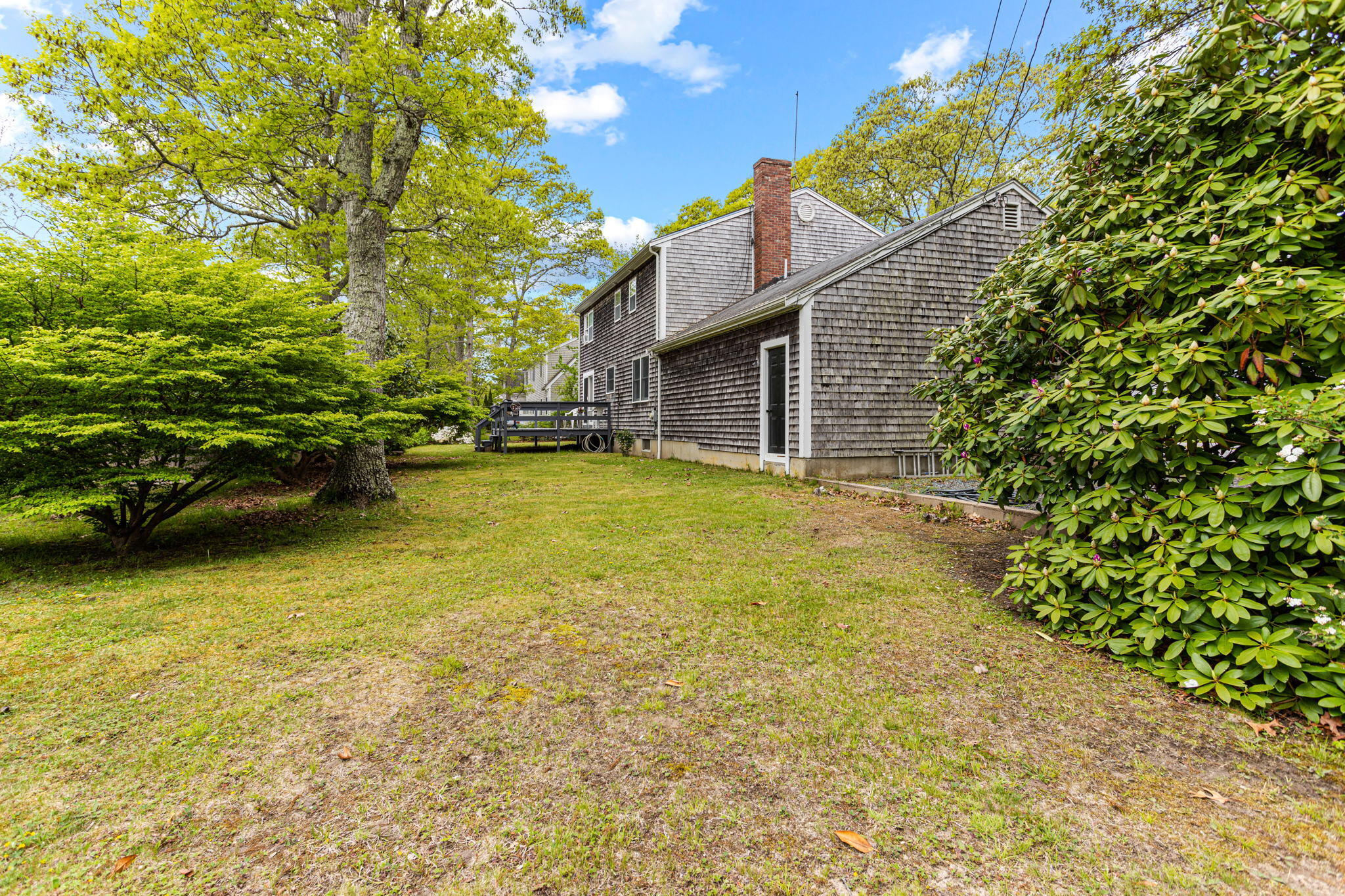 75 Lake Leaman Road Falmouth, MA 02540 - Photo 26 of 30 a view of a patio with table and chairs and potted plants