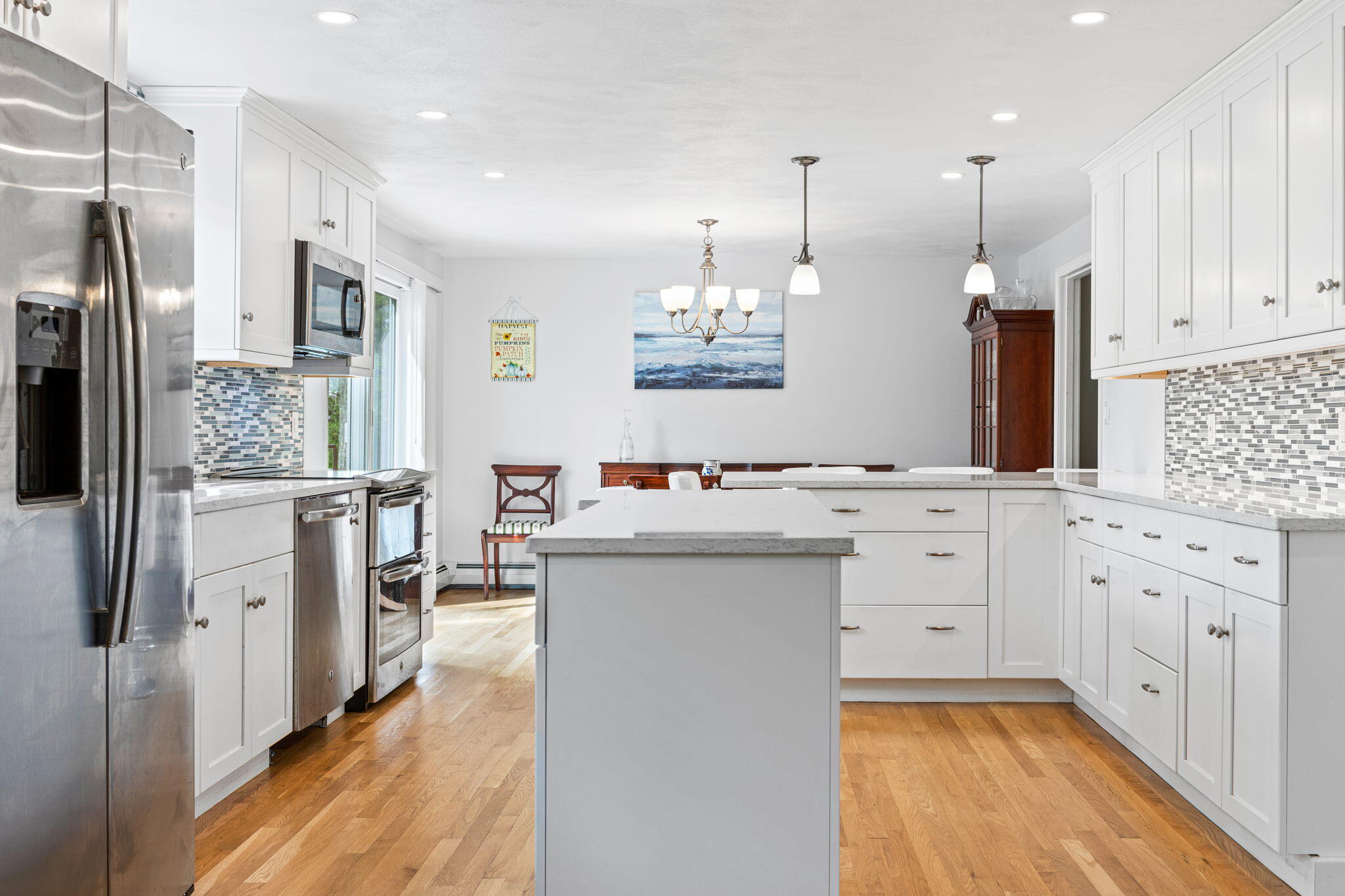 75 Lake Leaman Road Falmouth, MA 02540 - Photo 5 of 30 a kitchen with white cabinets and stainless steel appliances
