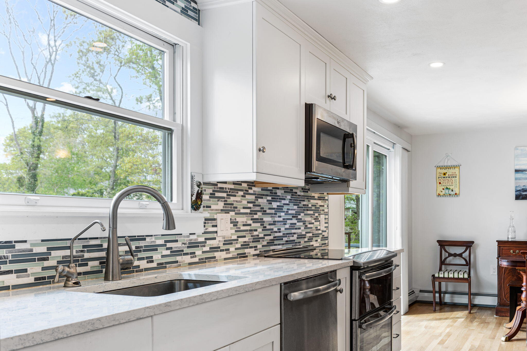75 Lake Leaman Road Falmouth, MA 02540 - Photo 7 of 30 a kitchen with granite countertop a stove a sink and a microwave