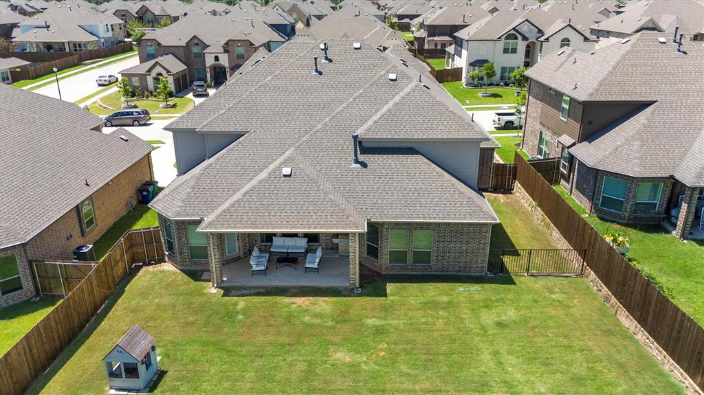 428 Piper Lane Fate, TX 75087 - Photo 29 of 33 Spacious backyard with a fenced-in dog run area