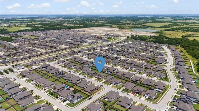 an aerial view of a house with a yard