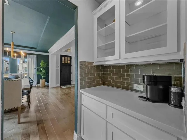 a view of open kitchen cabinets and window
