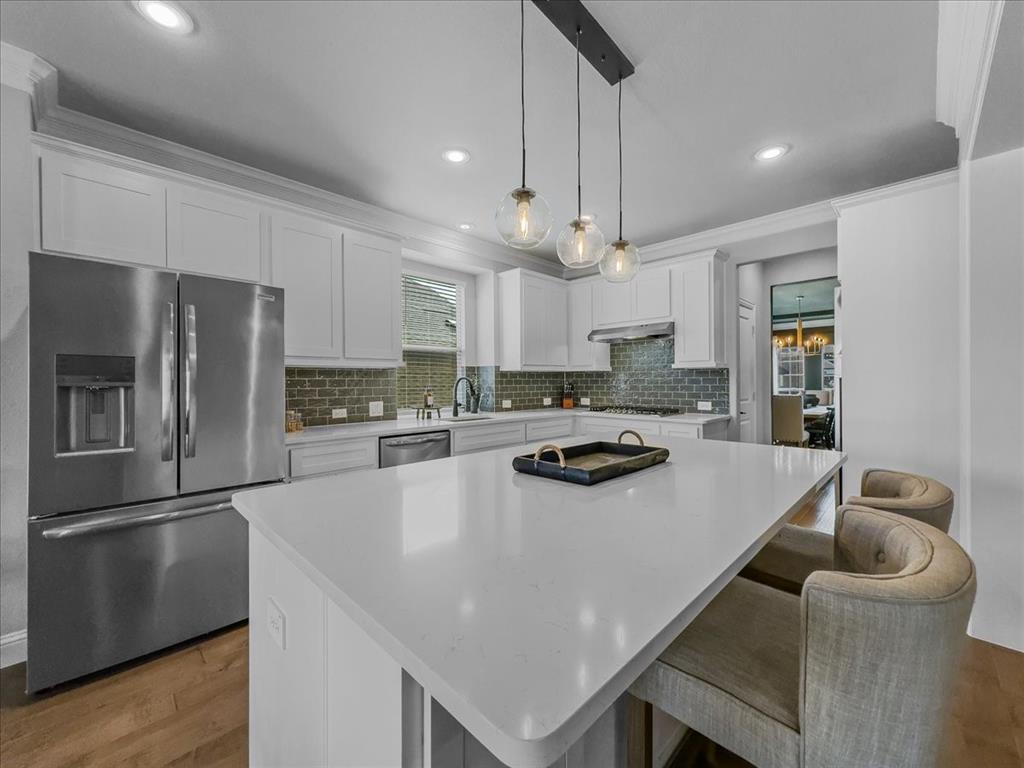 428 Piper Lane Fate, TX 75087 - Photo 6 of 33 Kitchen features a double oven and 5-burner gas range
