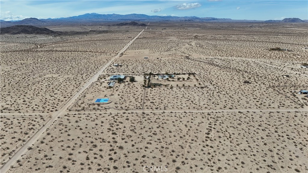 66220 Sonora Road Joshua Tree, CA 92252 - Photo 6 of 17 a view of a dry yard with wooden floor