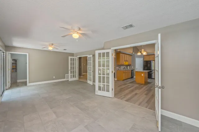 a view of a patio with a table and chairs under an umbrella
