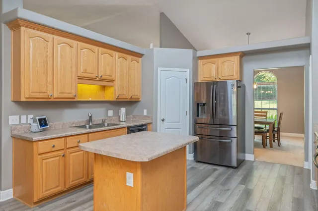 a bathroom with a granite countertop sink a toilet and a mirror