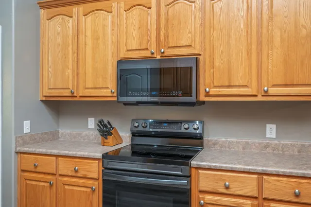 a bathroom with a granite countertop toilet sink and mirror