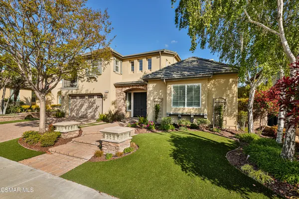 a view of a house with backyard sitting area and garden