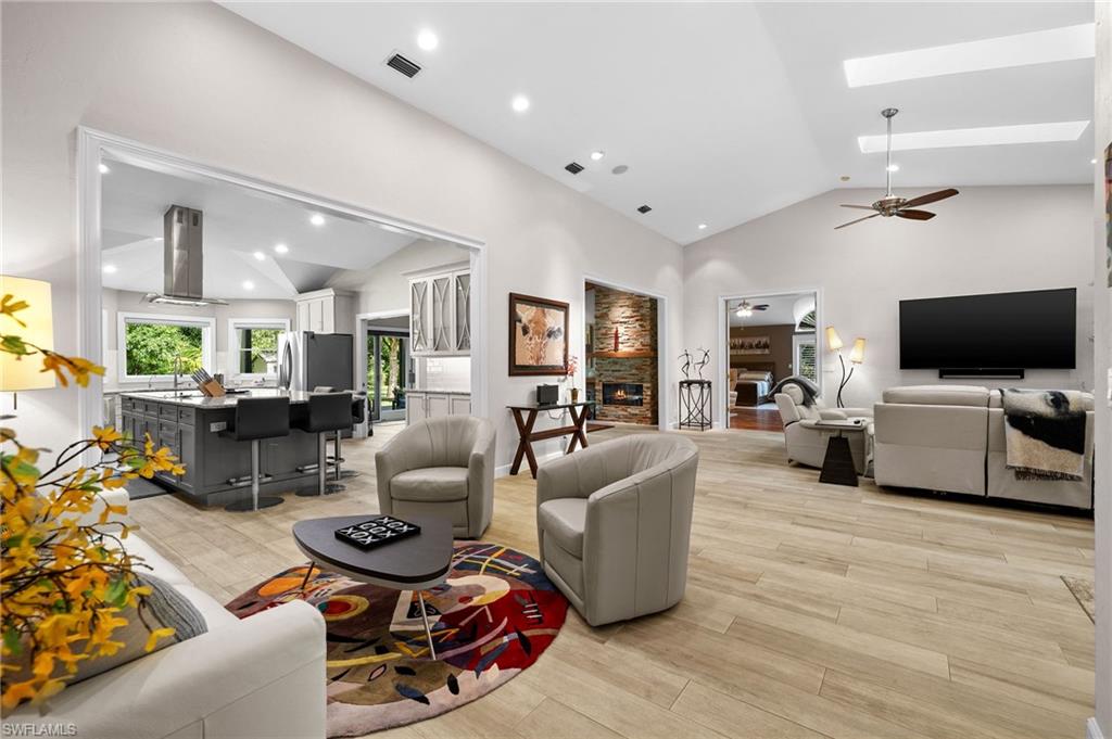 153 West Street Naples, FL 34108 - Photo 12 of 48 a living room with furniture and a flat screen tv