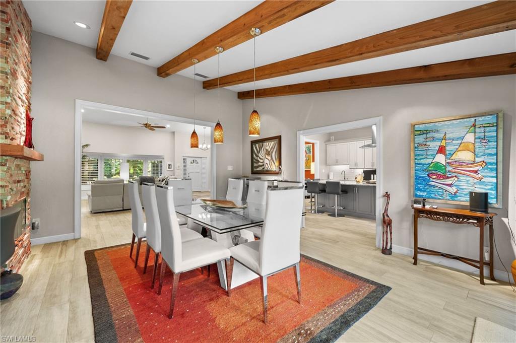 153 West Street Naples, FL 34108 - Photo 15 of 48 a living room with furniture a rug and a painting on the wall
