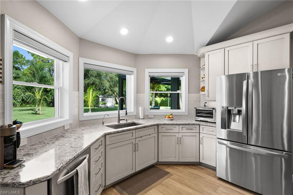 153 West Street Naples, FL 34108 - Photo 17 of 48 a kitchen with a sink window and refrigerator
