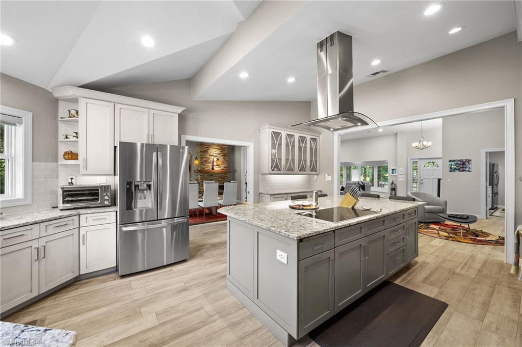 153 West Street Naples, FL 34108 - Photo 18 of 48 a kitchen that has a lot of cabinets and refrigerator