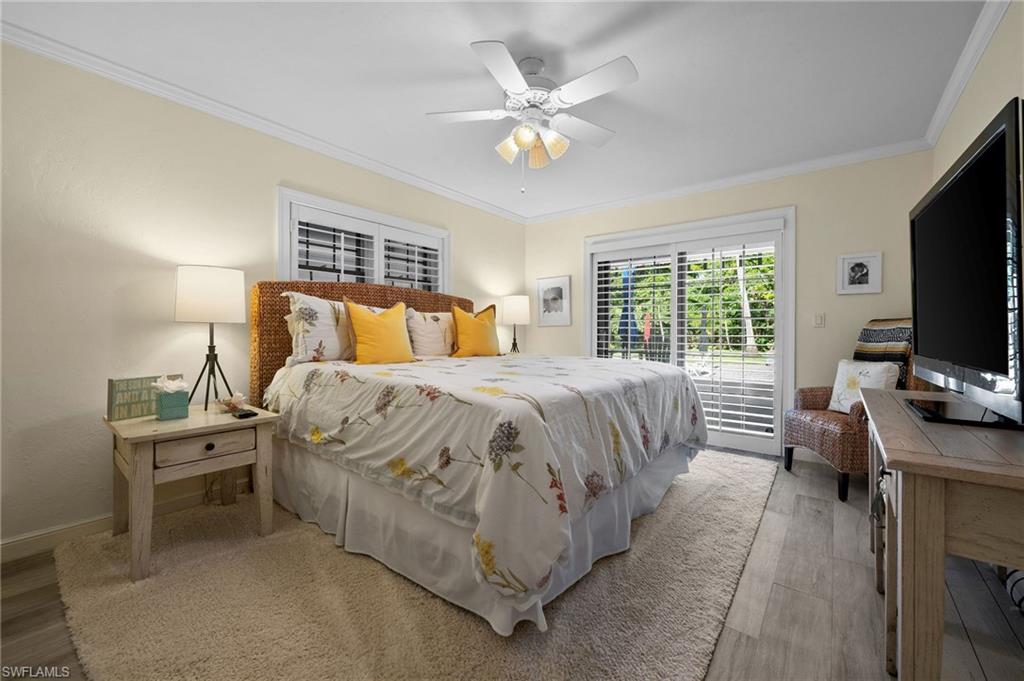 153 West Street Naples, FL 34108 - Photo 24 of 48 a bedroom with a bed and a flat screen tv