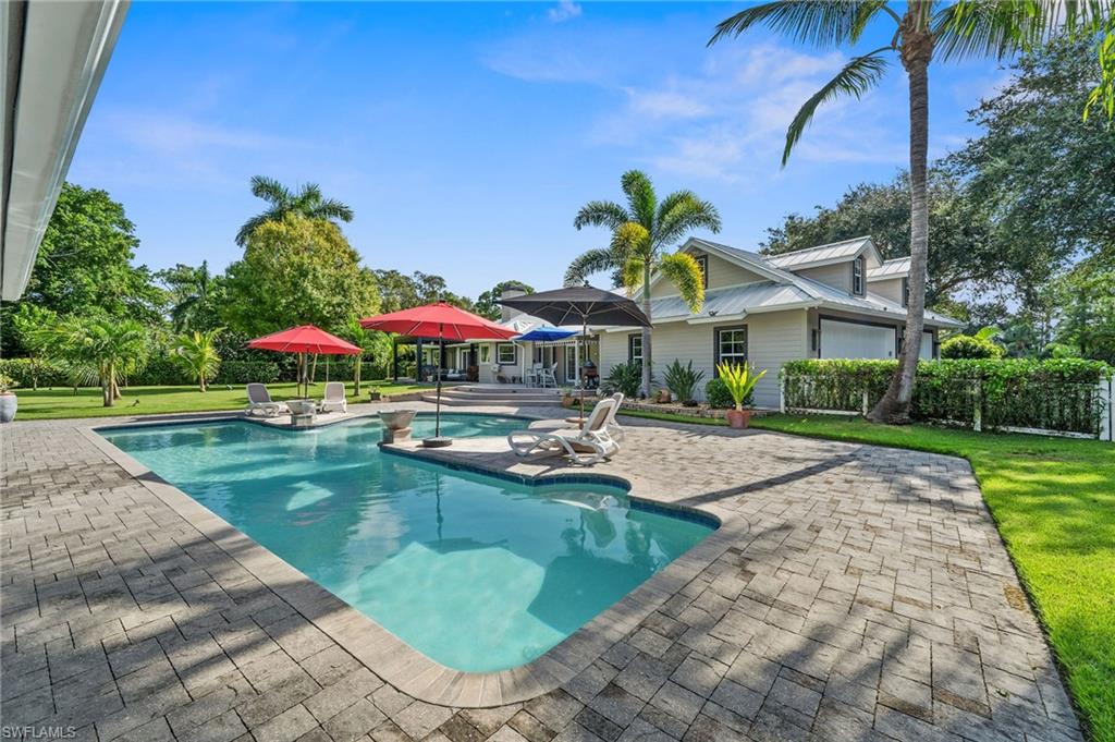153 West Street Naples, FL 34108 - Photo 36 of 48 a view of a house with swimming pool and sitting area