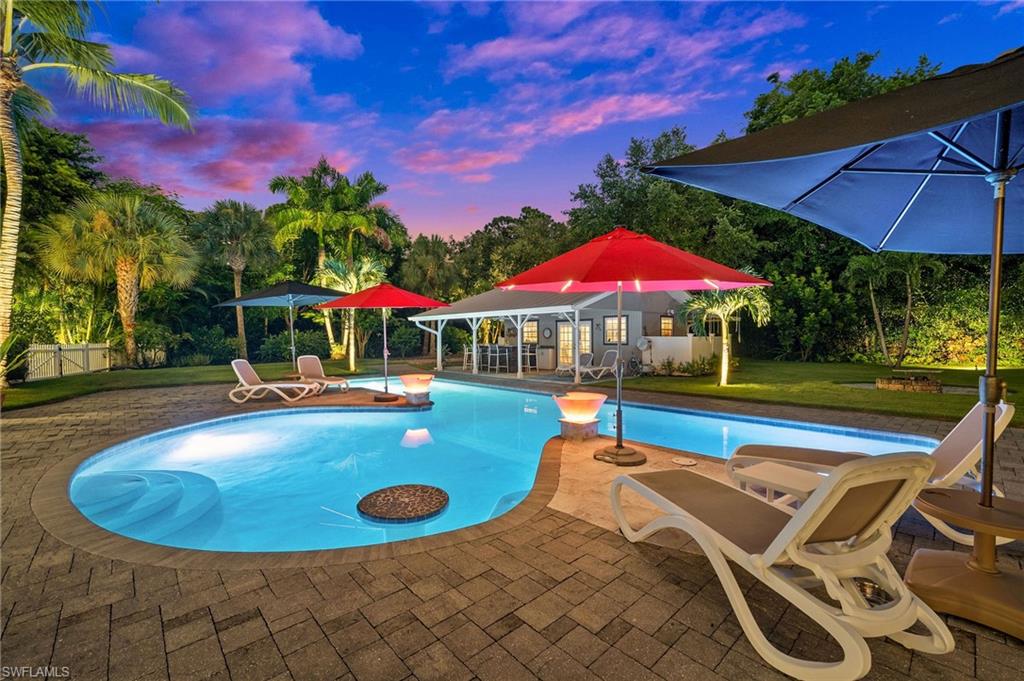 153 West Street Naples, FL 34108 - Photo 37 of 48 a view of a swimming pool with sitting area