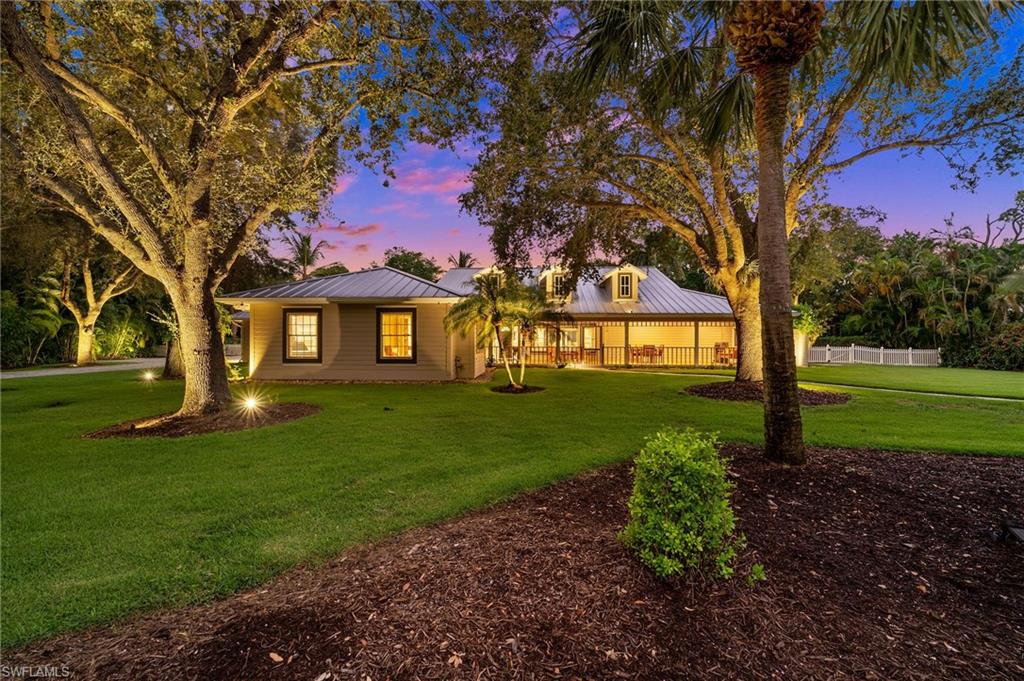 153 West Street Naples, FL 34108 - Photo 4 of 48 a view of a house with a yard