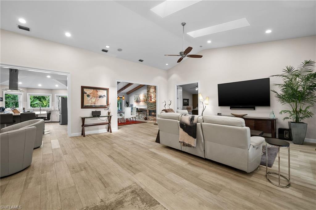 153 West Street Naples, FL 34108 - Photo 10 of 48 a living room with furniture and a flat screen tv