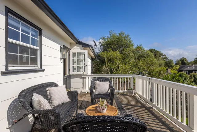 a view of a chairs and table on the roof deck