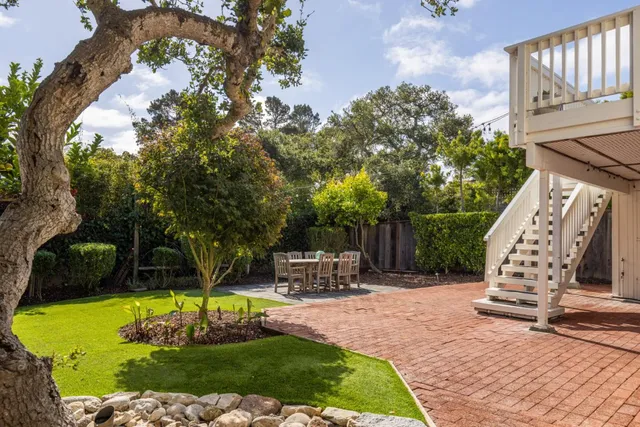a swimming pool with lots of tress in the background
