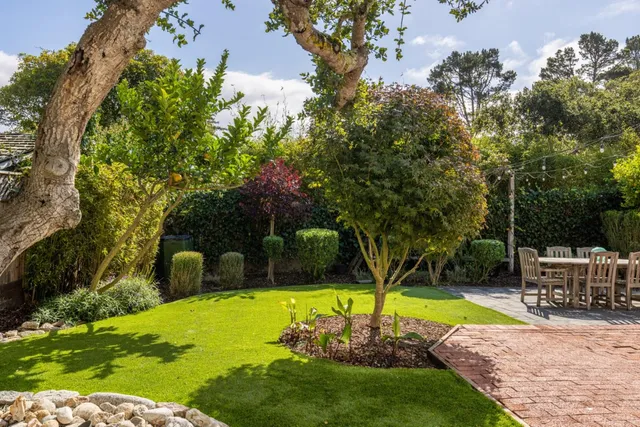 a view of a backyard with swimming pool