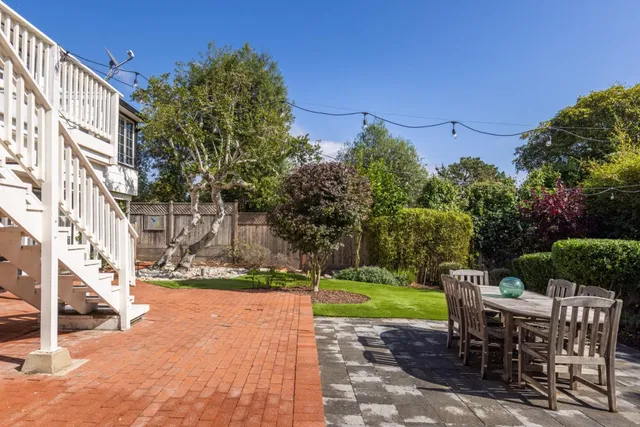 a view of backyard with seating and green space