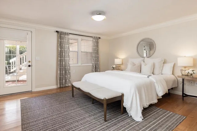 a bedroom with a bed lamp closet and window
