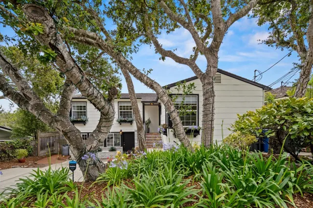 a front view of a house with garden