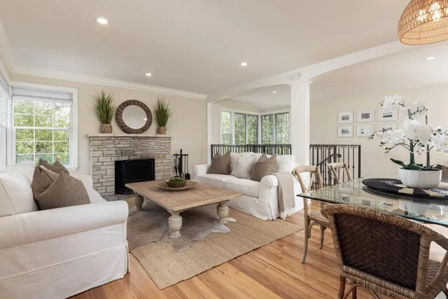 a living room with furniture a fireplace and a table