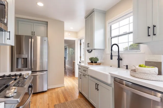 a kitchen with a refrigerator and a sink