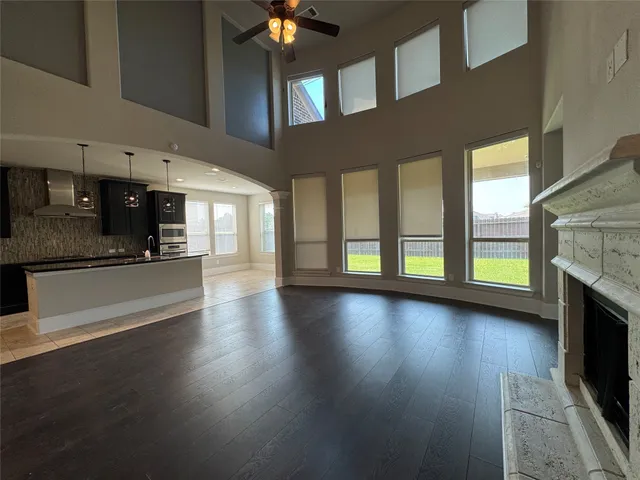 a view of a kitchen with a sink a fireplace a window and a kitchen