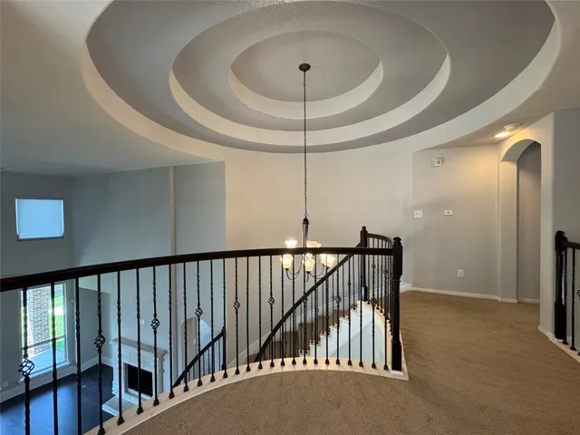 a view of staircase with railing and white walls