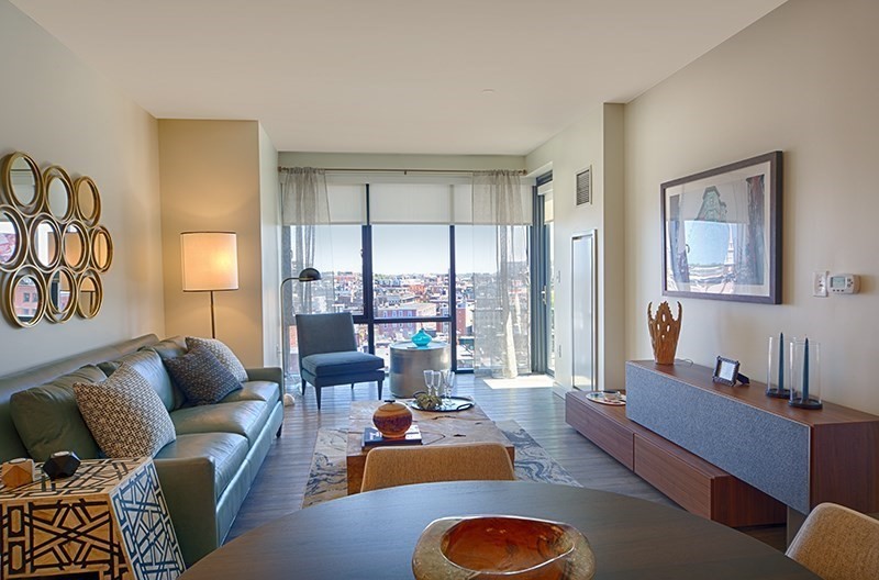 1 Canal Street, Unit 1012 Boston, MA 02114 - Photo 2 of 12 a living room with furniture floor to ceiling window and couch