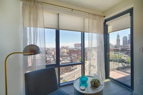 a living room filled with furniture and a floor to ceiling window