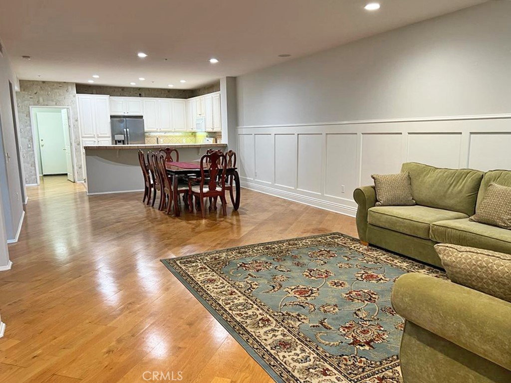 3 Leucadia Irvine, CA 92602 - Photo 2 of 30 a living room with a couch and kitchen view with wooden floor