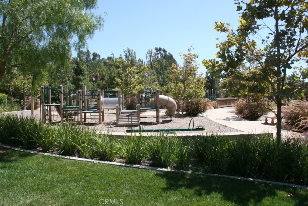 3 Leucadia Irvine, CA 92602 - Photo 23 of 30 a view of a patio with table and chairs potted plants and large tree