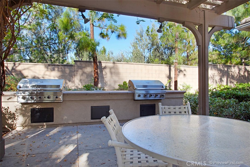 3 Leucadia Irvine, CA 92602 - Photo 30 of 30 a kitchen with stainless steel appliances kitchen island granite countertop a stove a sink and a microwave