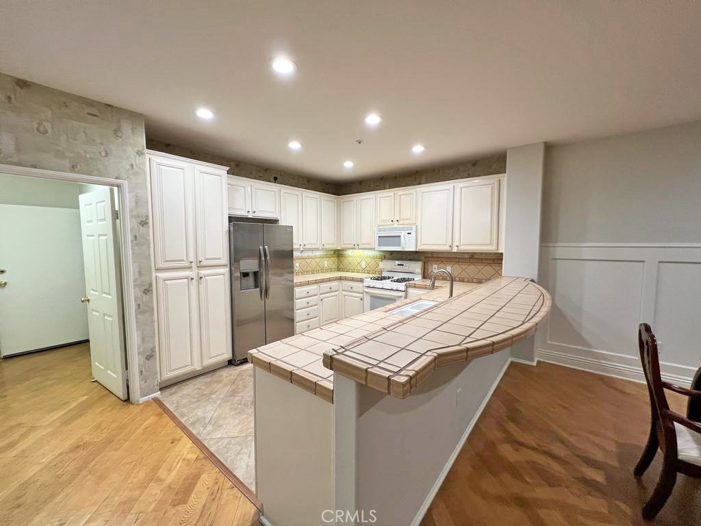 3 Leucadia Irvine, CA 92602 - Photo 3 of 30 a kitchen with refrigerator and cabinets