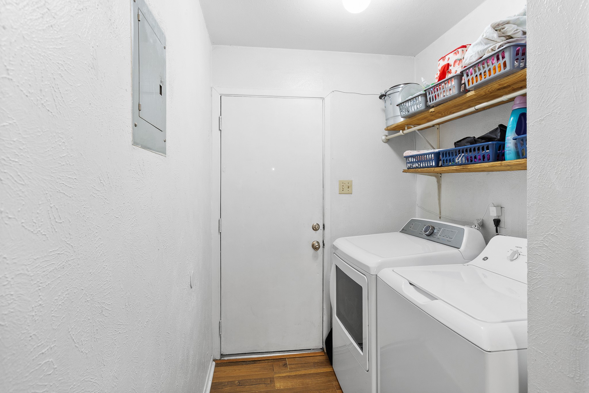 606 Misty Morning Way, Unit A AND B Round Rock, TX 78664 - Photo 10 of 22 Laundry area featuring dark wood-style floors, a textured wall, separate washer and dryer, and electric panel