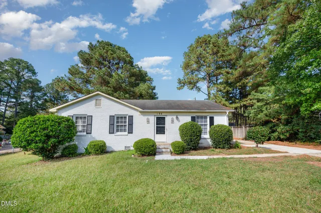 a picture of a bench in front of a white house