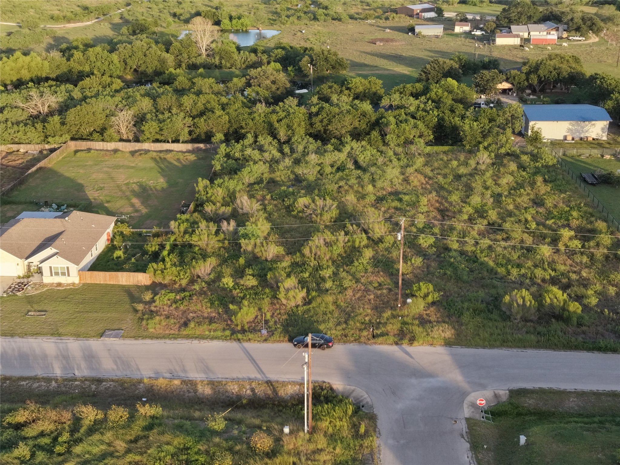 232 East Ridge Lane Kyle, TX 78640 - Photo 26 of 36 A spacious lot with abundant natural greenery and a clear view of the surrounding rural landscape.