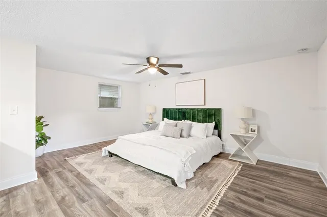 a bedroom with a bed and a chandelier