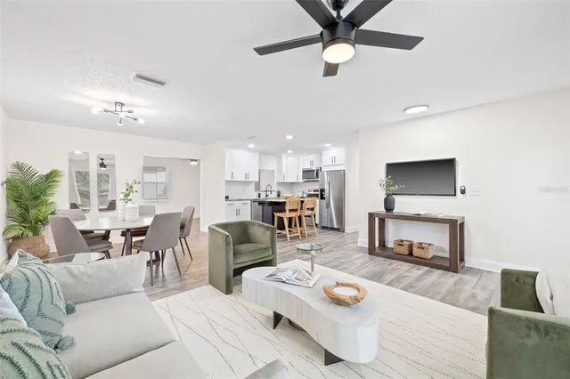 a living room with furniture kitchen view and a fireplace