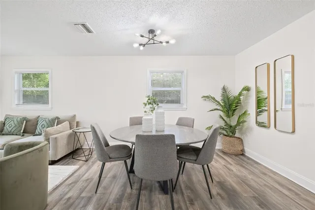 a view of a dining room with furniture wooden floor and a chandelier