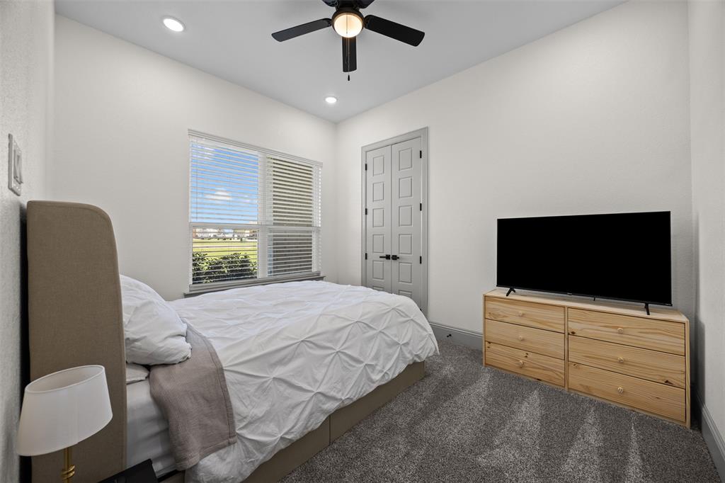 6317 Vega Road Godley, TX 76044 - Photo 22 of 27 a bedroom with a bed and a flat screen tv