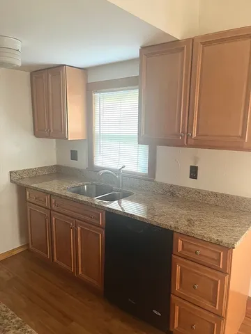 a kitchen with stainless steel appliances granite countertop a sink stove and cabinets